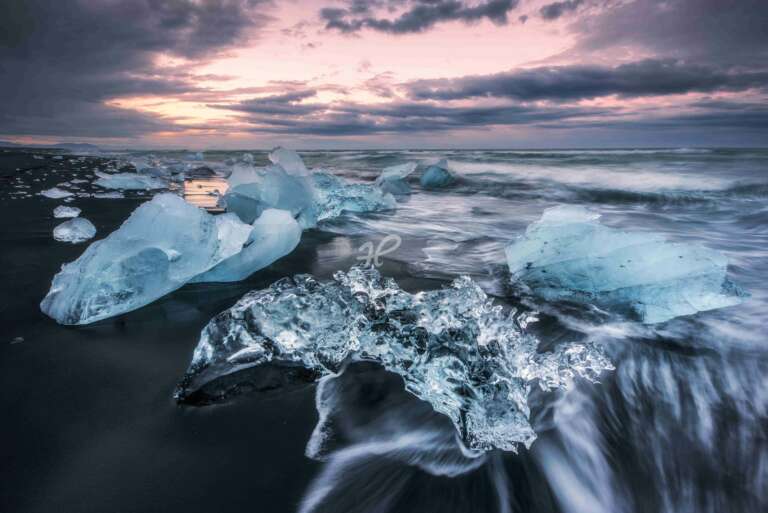 Eisbrocken am schwarzen Diamond Beach zum Sonnenuntergang in Island
