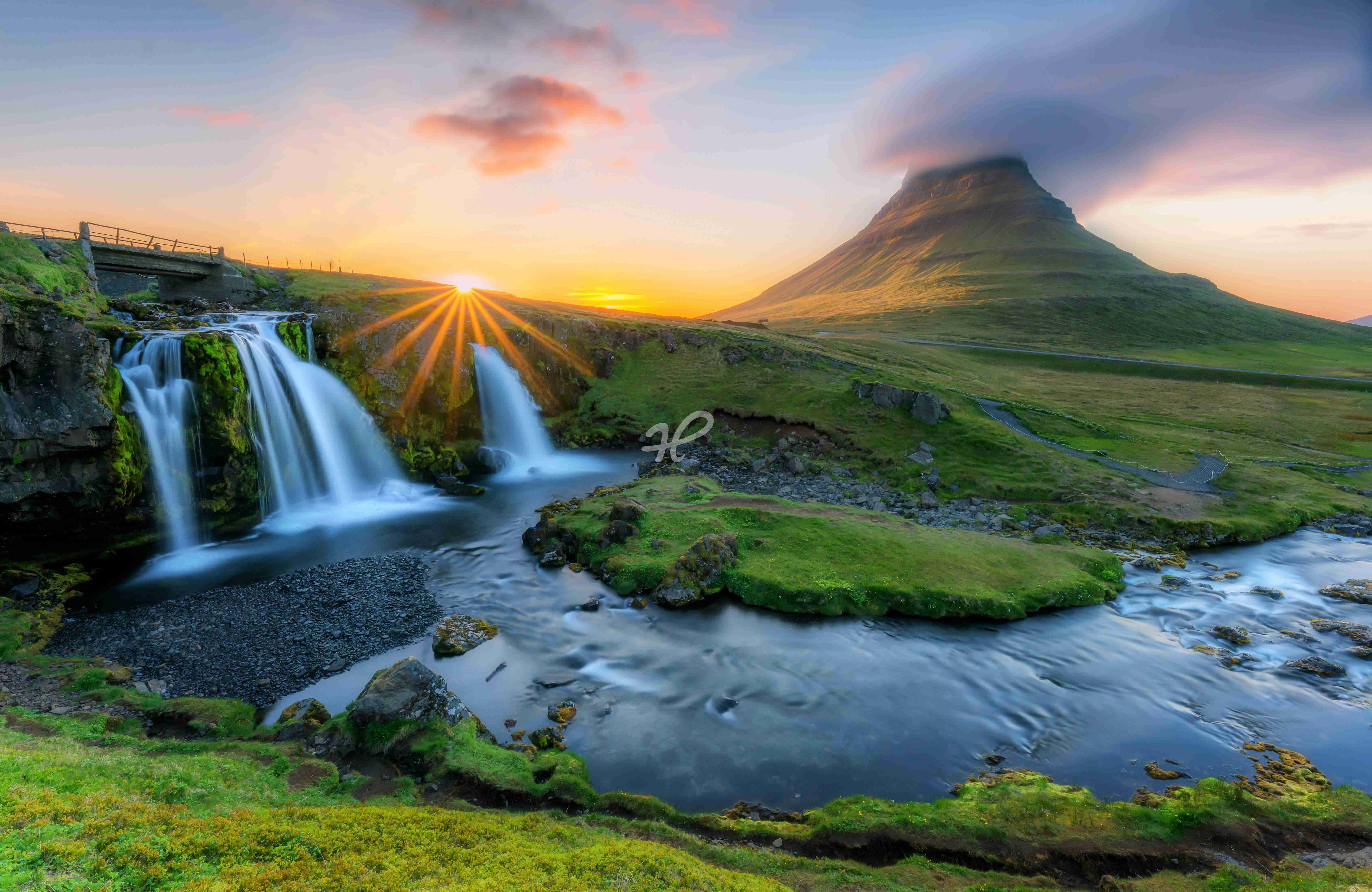 Sonne, Berge und Wasser auf Island mit Wasserfall